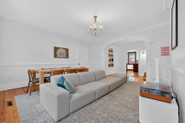 a view of a livingroom with furniture and hardwood floor