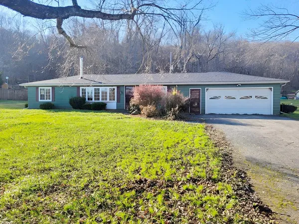 a front view of house with yard and seating