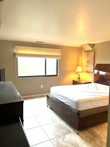 a bedroom with a bed and window