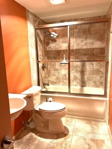 a bathroom with a bathtub and next to a window