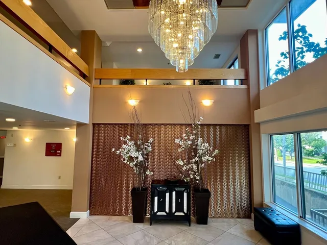 a view of entryway and hall with a chandelier