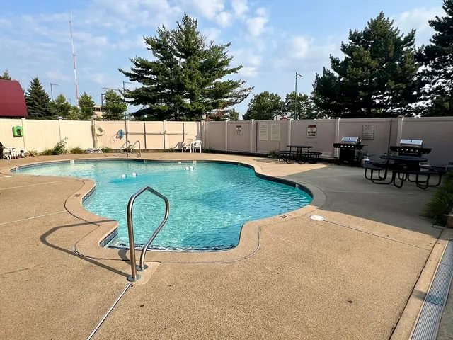 a view of a swimming pool and lounge chair