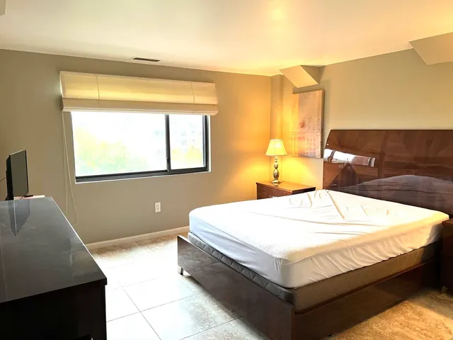 a bedroom with a bed and window