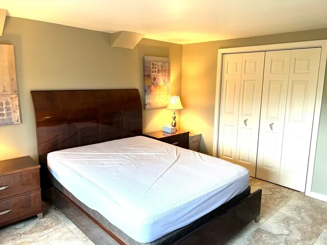 a bedroom with a bed and window