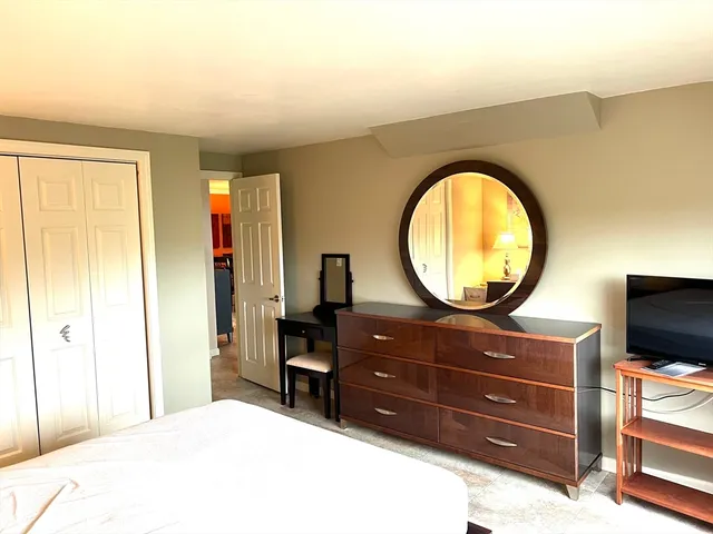 a living room with furniture and a mirror