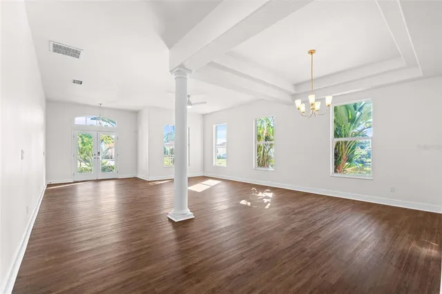 a kitchen with granite countertop white cabinets and a window