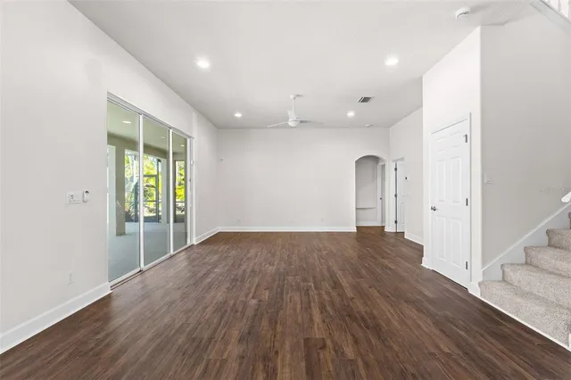 a view of a livingroom with white kitchen