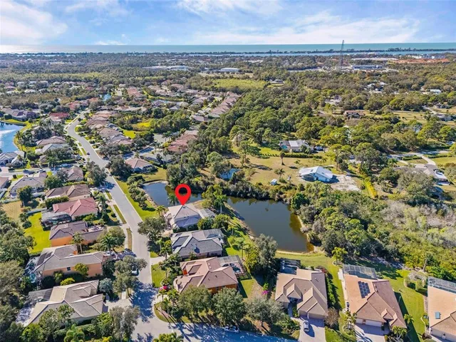 an aerial view of residential building and lake