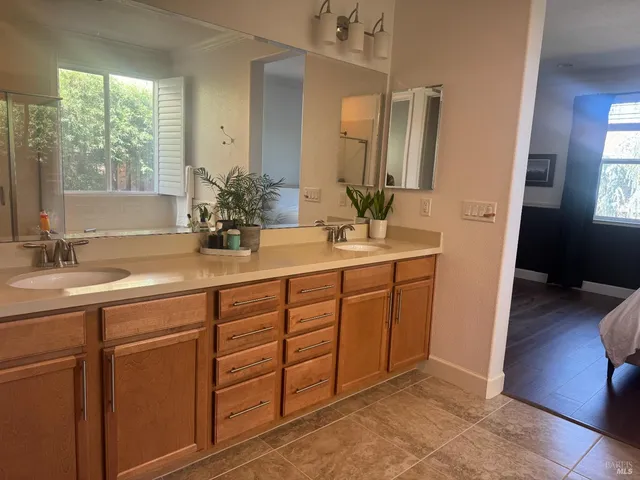a bathroom with a double vanity sink and a mirror