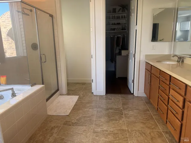 a bathroom with a tub sink and mirror