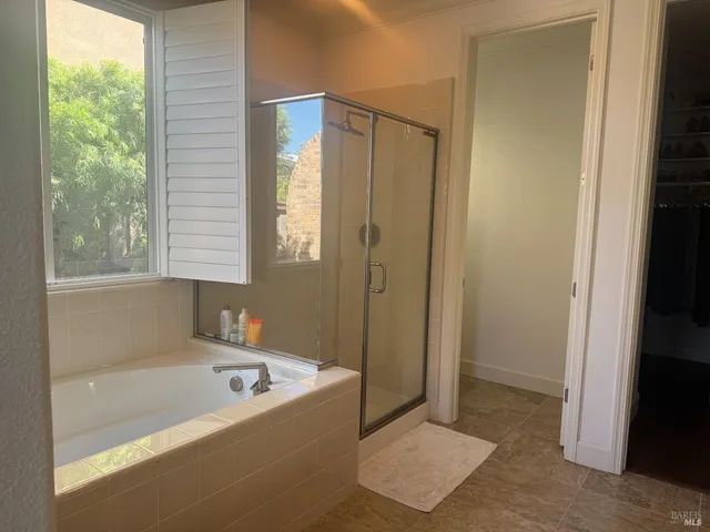 a bathroom with a tub shower and sink