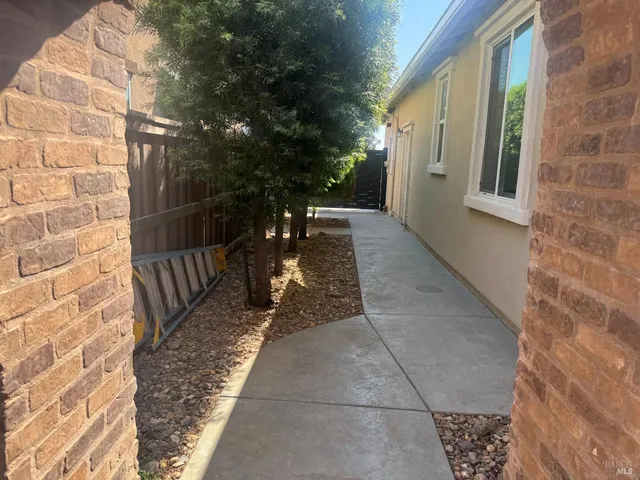 a view of a patio with a table chairs and a backyard