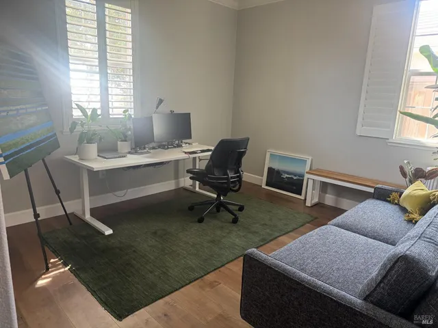 a living room with furniture rug and window