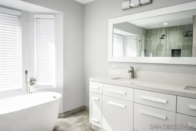a bathroom with a sink a vanity and a bathtub