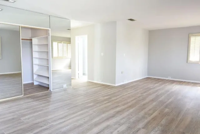 wooden floor in an empty room with a window