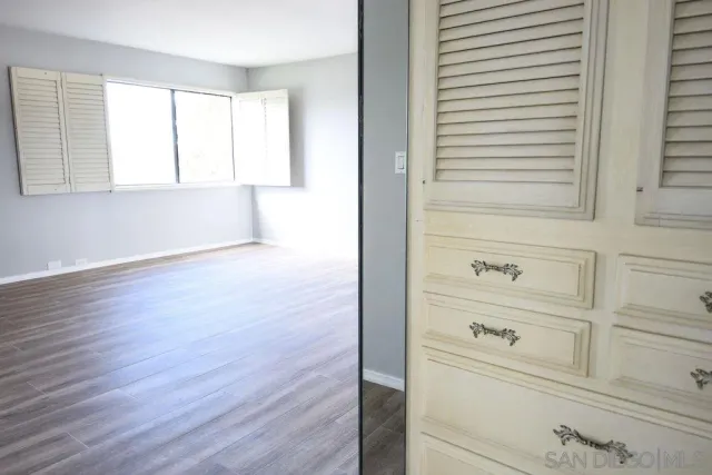 wooden floor with window and fireplace