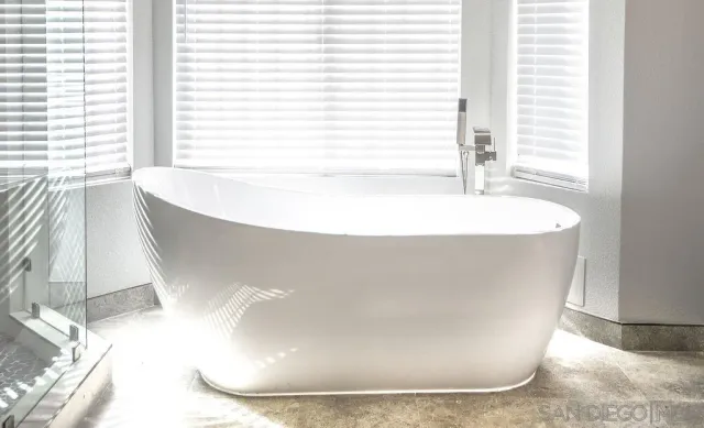 a white bath tub sitting in a bathroom