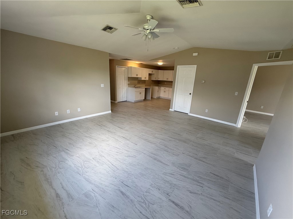 4547 21st Street Southwest Lehigh Acres, FL 33973 - Photo 5 of 12 wooden floor in an empty room with a window