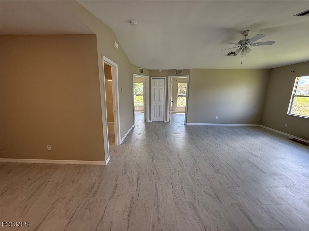 4547 21st Street Southwest Lehigh Acres, FL 33973 - Photo 9 of 12 a view of an empty room with a window and wooden floor