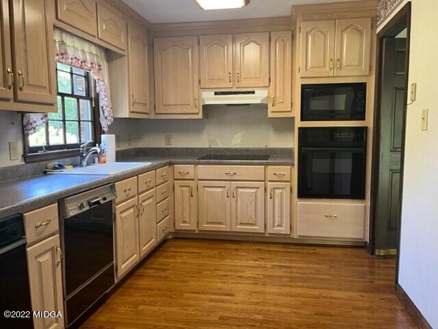 6872 Columbus Road Lizella, GA 31052 - Photo 6 of 21 a kitchen with stainless steel appliances granite countertop a stove a sink and a microwave