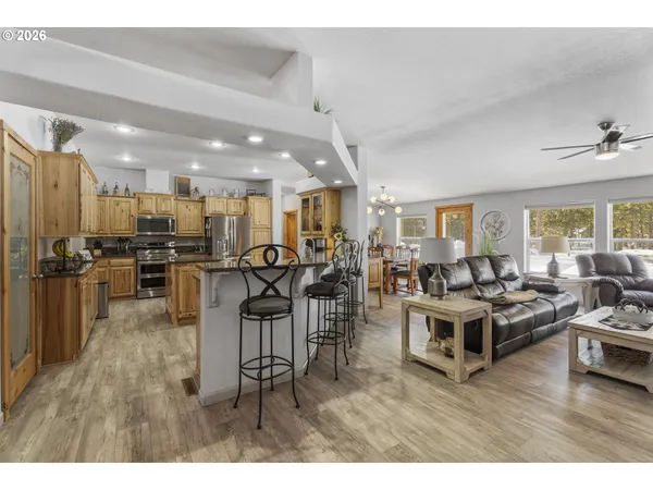 a living room with lots of furniture and kitchen view