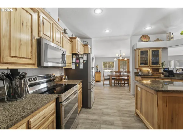 a kitchen with stainless steel appliances granite countertop a stove and a sink