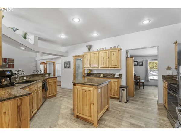 a kitchen with stainless steel appliances granite countertop a stove top oven