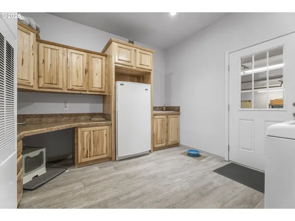 a kitchen with refrigerator cabinets and wooden floor