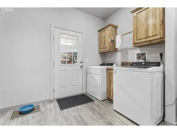 a kitchen with cabinets and wooden floor