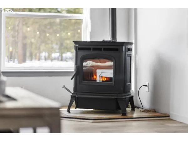a living room with a fireplace and a window