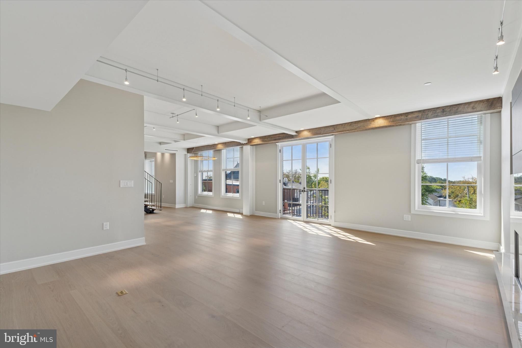 50 North Main Street, Unit 302 Doylestown, PA 18901 - Photo 11 of 33 an empty room with wooden floor and windows