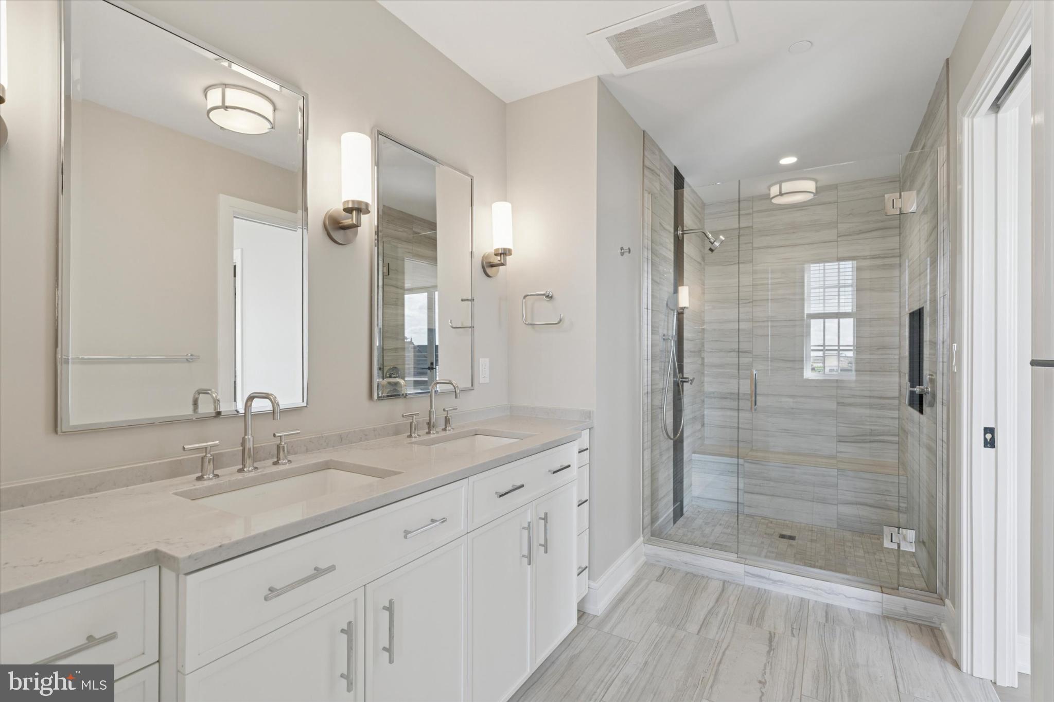 50 North Main Street, Unit 302 Doylestown, PA 18901 - Photo 18 of 33 a bathroom with a shower tub double vanity and a glass door shower