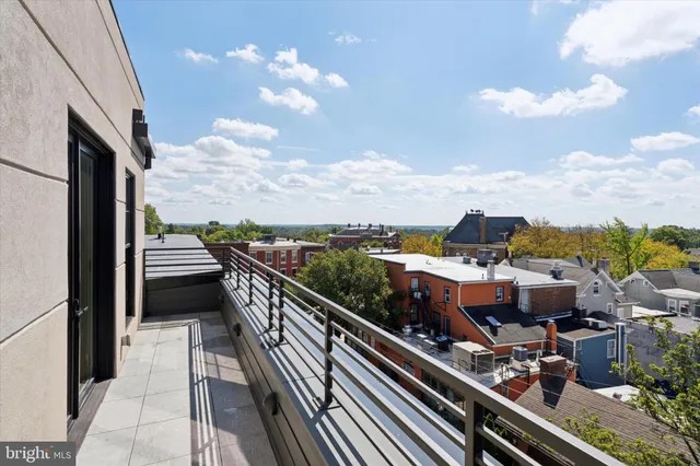an empty room with windows and entrance to other room