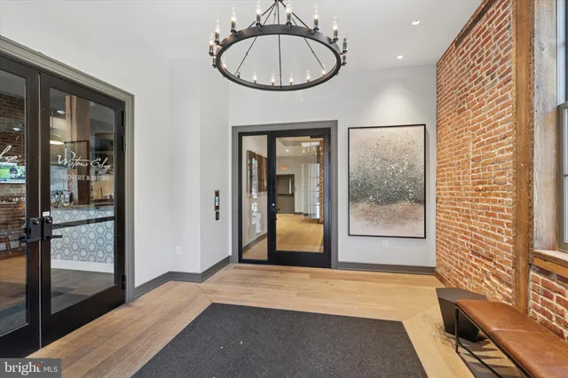 a view of a room with wooden floor and a chandelier