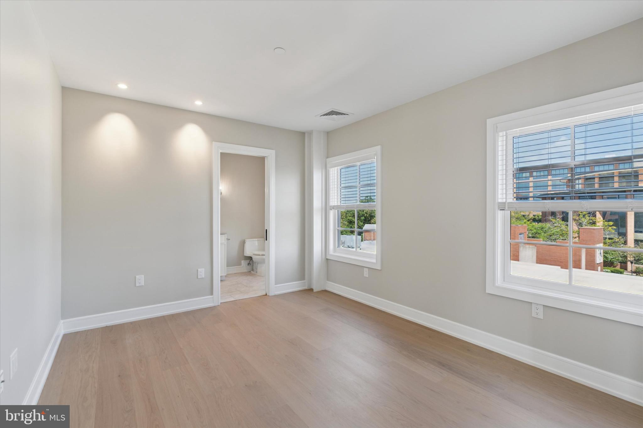 50 North Main Street, Unit 302 Doylestown, PA 18901 - Photo 21 of 33 an empty room with windows and entrance to other room