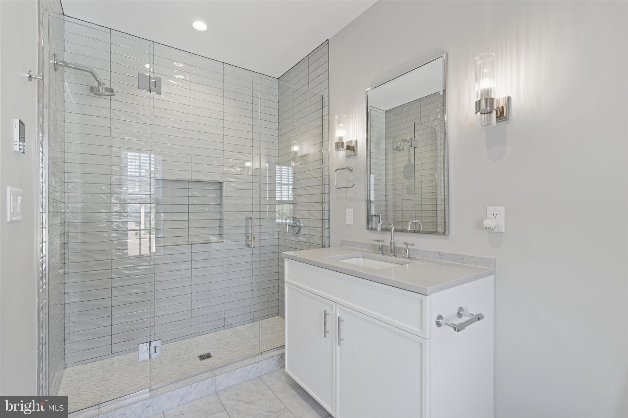 50 North Main Street, Unit 302 Doylestown, PA 18901 - Photo 22 of 33 a bathroom with a shower sink and mirror