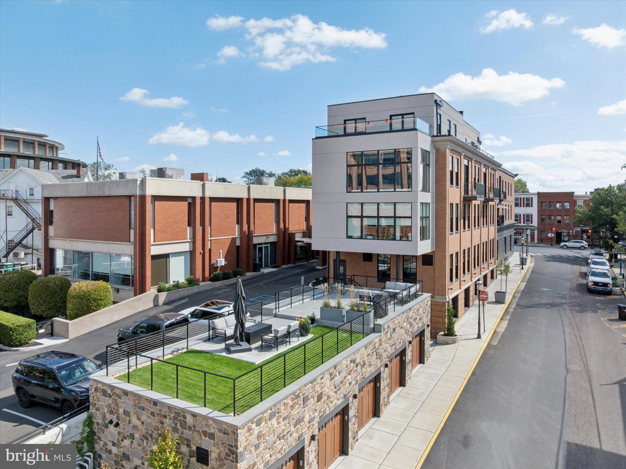 50 North Main Street, Unit 302 Doylestown, PA 18901 - Photo 25 of 33 a view of a house with pool and chairs