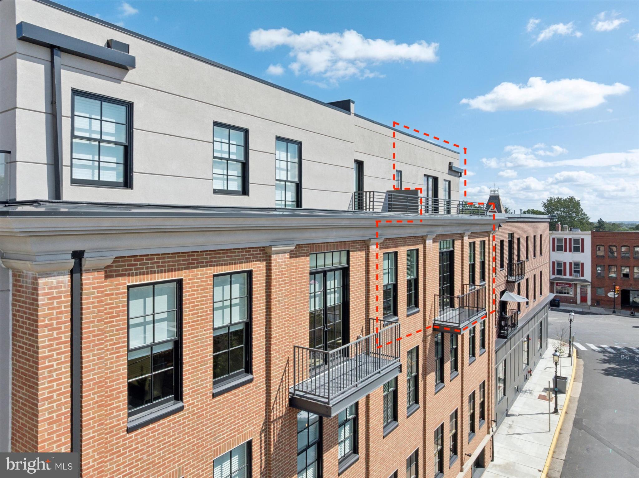50 North Main Street, Unit 302 Doylestown, PA 18901 - Photo 29 of 33 a view of a brick house with a large window and wooden floor