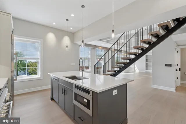 a kitchen with a stove sink and a window