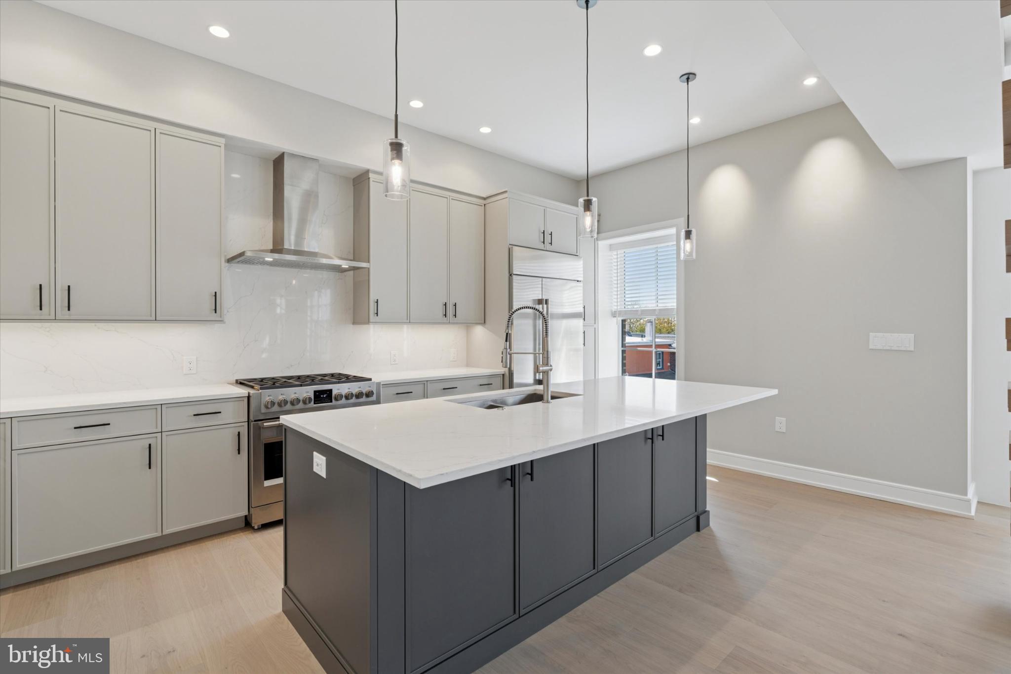 50 North Main Street, Unit 302 Doylestown, PA 18901 - Photo 6 of 33 a kitchen with a sink a stove a refrigerator and white cabinets