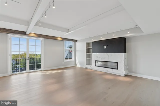 an empty room with a fireplace and window