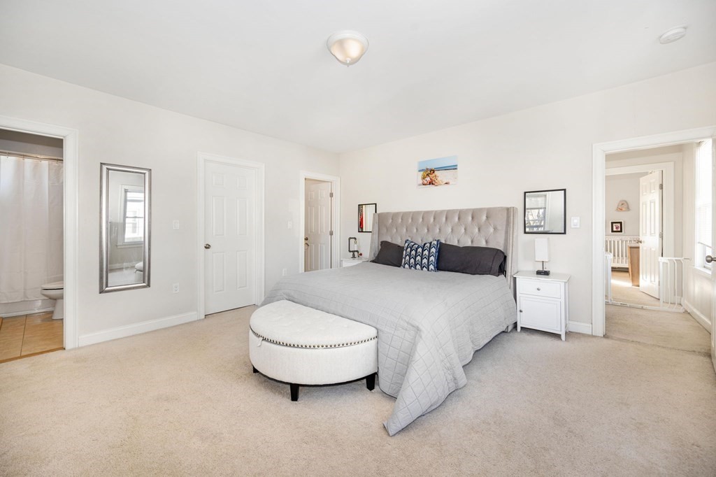15 Vine Street Medford, MA 02155 - Photo 13 of 23 a spacious bedroom with a bed and wooden floor