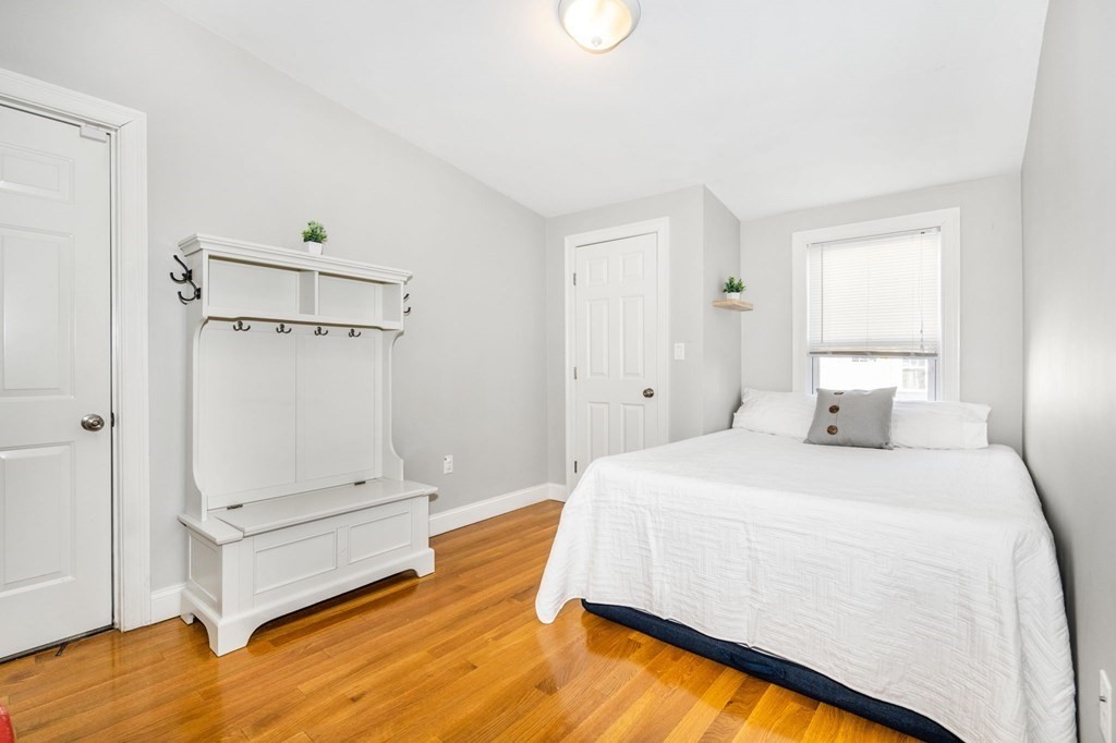 15 Vine Street Medford, MA 02155 - Photo 15 of 23 a spacious bedroom with a bed and a dresser