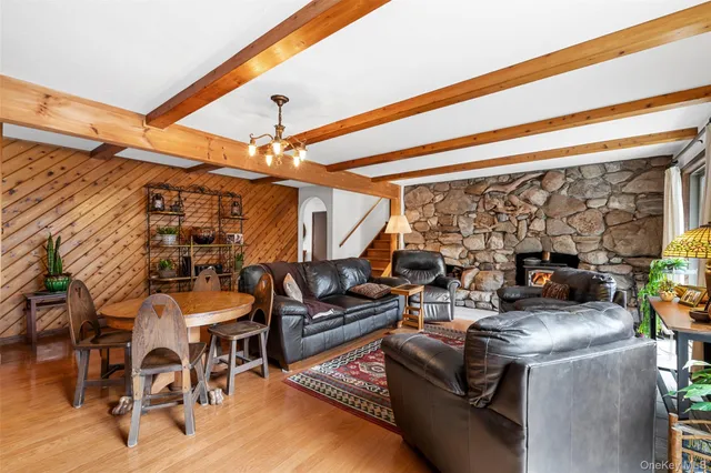 a view of a livingroom with furniture and floor to ceiling window