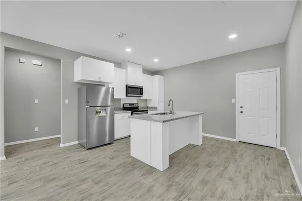 a kitchen with stainless steel appliances a refrigerator and a sink