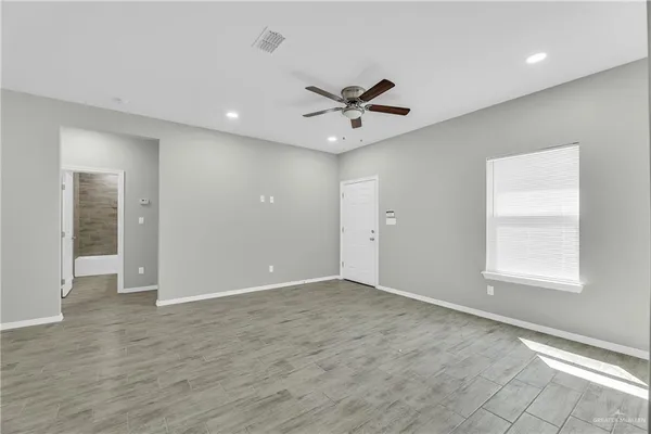wooden floor in an empty room with a window