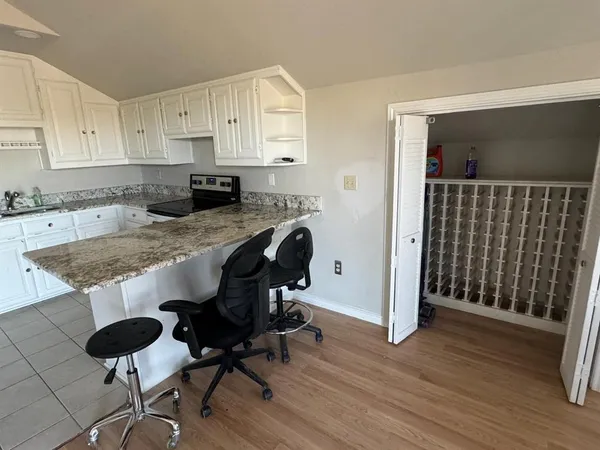 a view of kitchen with cabinets