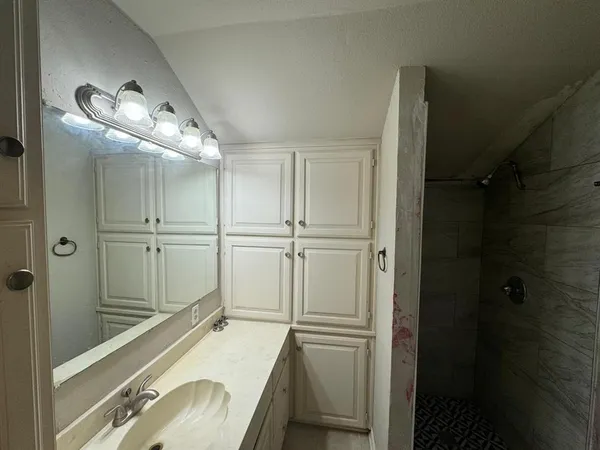 a bathroom with a tub and a sink