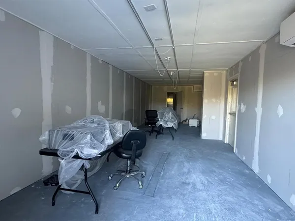 a view of a room with a table and chairs