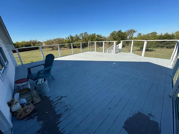 a view of a chairs and table on wooden deck